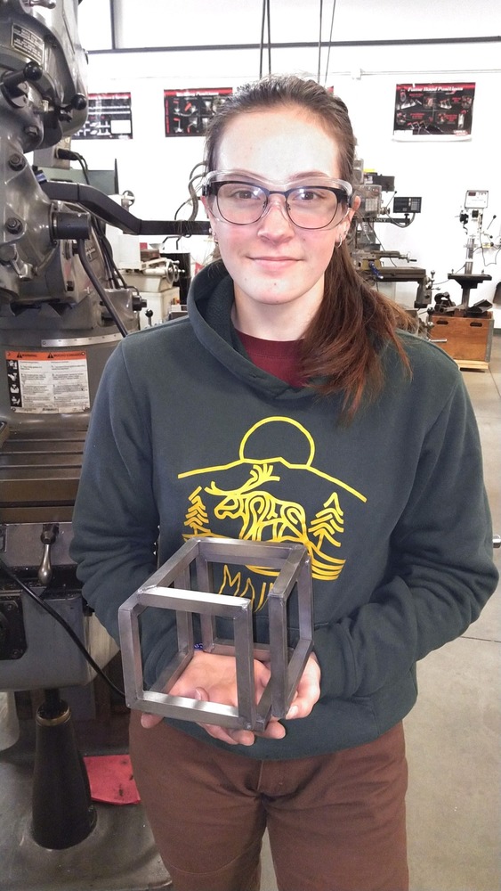 Student holding a fabricated 